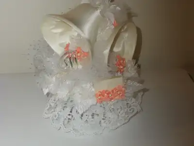 Cake Topper of Bells with tulle, white and coral/peach flowers. Lace around the base and silver spar...