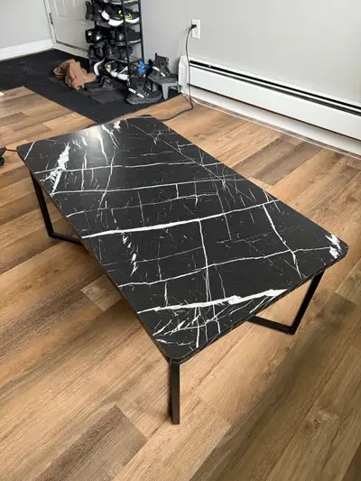This black coffee table features a faux marble top with white veining, adding a touch of modern eleg...