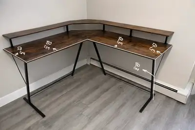 This corner desk features a spacious work surface, perfect for home offices or gaming setups, but it...