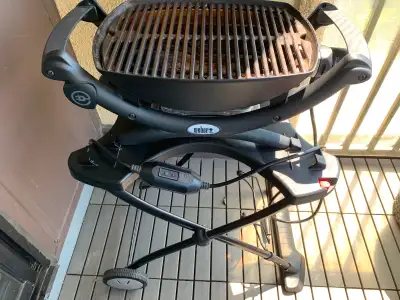 Weber Q 1400 outdoor portable electric grill. Comes with cart and cover. Note: This grill is intende...