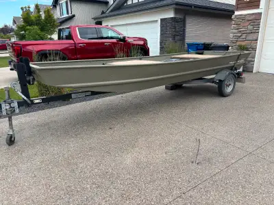 15 ft Tracker topper Jon boat with 20hp tohatsu engine that was only ran once. Efi engine. Comes wit...