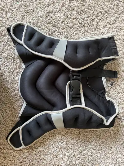 This black weighted vest is a fantastic tool to intensify your fitness routine and add extra resista...