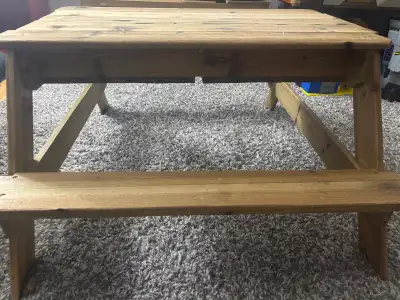 This is a wooden picnic table, perfect for kids. The table is in good condition, used only indoors....