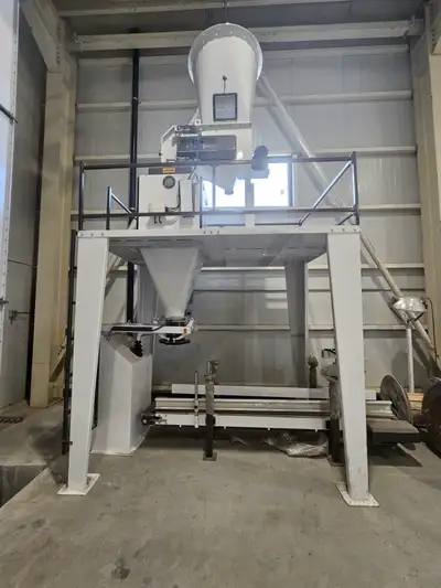 The operator sets the target weight at the electrical panel; the weight and bag count are displayed...