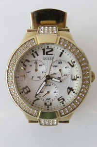 Guess watch, 40mm round gold metal case, silver dial with three