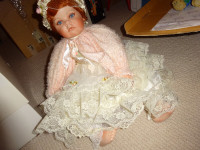 Porcelain doll by Rustie; 25 inch,lovely,in box,mint