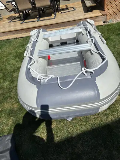 Bris inflatable boat. Aprox 10 ft. The boat has aluminum floors and benches. Comes with foot pump, o...