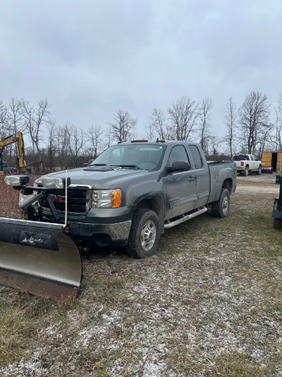 2011 GMC Sierra 2500 with tonneau cover and plow (8 foot). 180K mileage. Runs well but needs body wo...