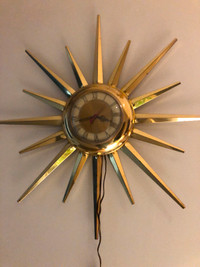 Mid century United brass starburst electric wall clock.