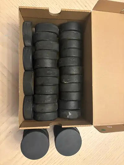 Box of 34 used pucks, View more