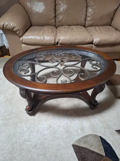 This is an oval glass top -Ashley Design coffee Table. Currently selling on Amazon for $659.00. This...