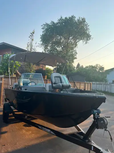 Versatile black aluminum fishing boat with 5 seats. Has a 150hp Mercury Optimax is main motor and a...