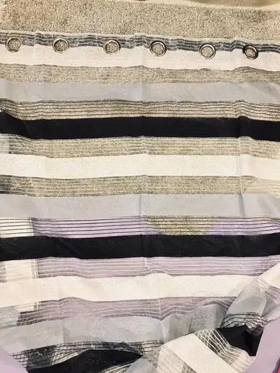 Add a touch of elegance to your home with this stylish black, grey, and white striped curtain panel,...