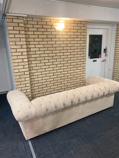 Selling a beige tufted chesterfield sofa. It's in good condition and would look great in any living...