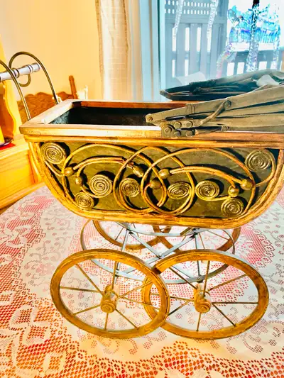 This vintage doll stroller is a delightful piece from a bygone era, perfect for collectors or as a u...