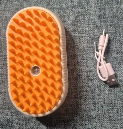 This electric spray massage brush is designed to gently groom and massage your pet, featuring soft b...