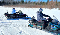 Two snowmobiles and sled