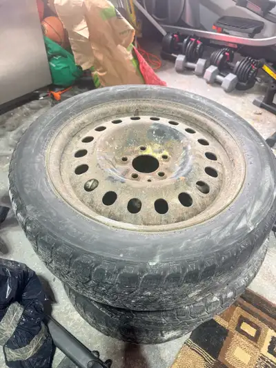 SEt of snow tires on steel rims, size 215/55R17. They're ready for winter conditions. Some rust on t...