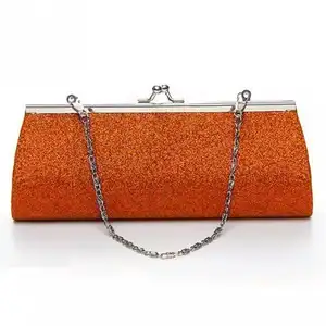 Add a touch of sparkle to your evening with this glittery orange clutch featuring a kiss lock closur...