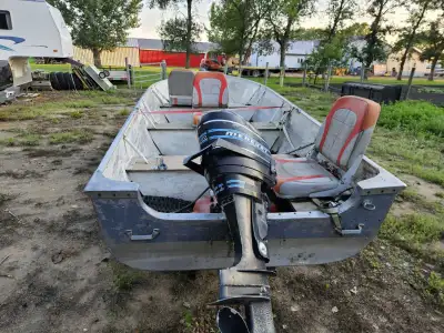 The boat comes with the trailer and a back mount trolling motor it has a 20 hp mercury bottom end is...