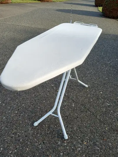 This Folding Ironing Board is in Like New Condition. Has a Metal Iron Holder with Adjustable Cord Ar...