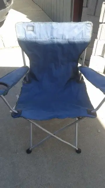 Blue folding camp chair... No bag... Works fine... Fabric is a little frayed on the edge... $5.00 ca...