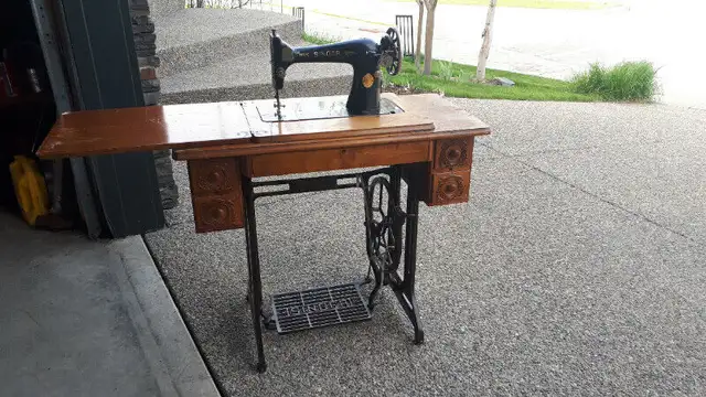 Singer Treadle Sewing Machine in the original Wooden Cabinet.