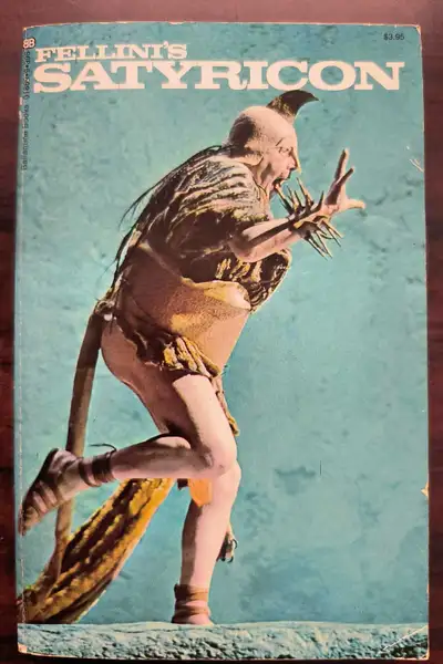 This is a paperback edition of Fellini's "Satyricon". It features a number of essays, and the screen...