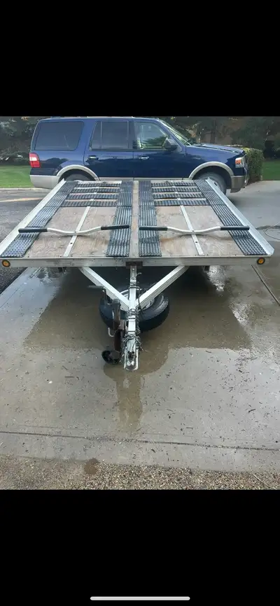 Double Tilt aluminum trailer -dimensions 8’W x10’L -2 inch ball -fits two snowmobiles -front screw b...