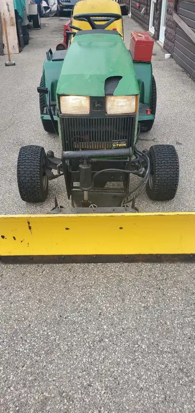 I'm selling a John Deere 425 lawn tractor, ready to tackle your yard work or snow removal tasks with...
