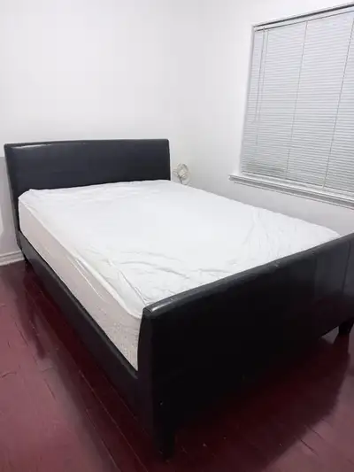 Clean and nice queen bed with a dark brown leather bed frame and a mattress in great condition avail...
