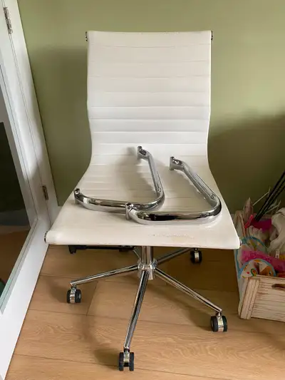 Heavily used office chair with removable arms. Some peeling of leather on bottom and top of chair. O...