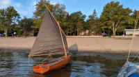 Wooden cedar strip sailboat with oars in excellent condition