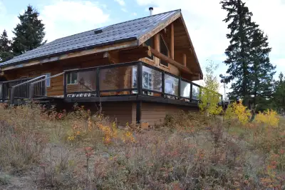 Charming open-concept log home, tucked beside a serene lake, built on a durable, concrete-filled sty...