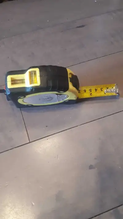 This is a used, but still very functional, measuring tape that includes a laser level. It's perfect...
