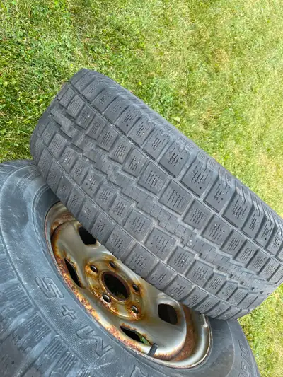 Well used ram steel wheels with worn Cooper tires. 5 bolt pattern. Surface rust on wheels. Tires wor...