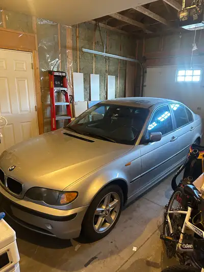 Silver BMW 320i sedan with black leather interior. This car features automatic transmission and a su...