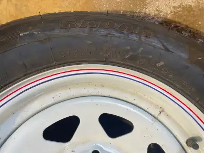 Size: ST225/75R15 Tire and rim were purchased as a spare for trailer but has never been used. Traded...