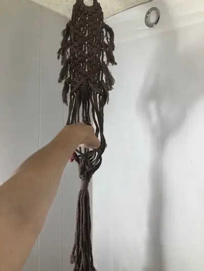 Brown Woven Macrame Plant Hanger. NEW. Will hold up to a 6” pot Can also hang in a wall. Brand new....