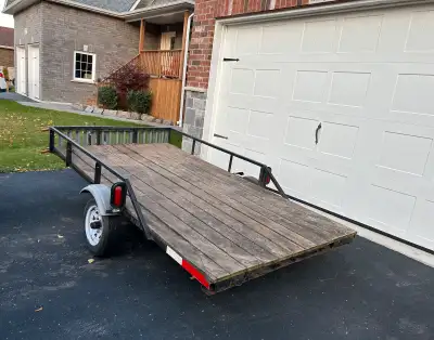 Versatile multi-purpose utility dump trailer with built-in ramps. In good condition, but may need so...