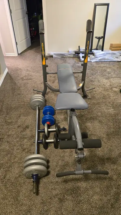 Bench has barbell racks, leg curl, leg extension, and removable bar for bicep curls. Also has weight...