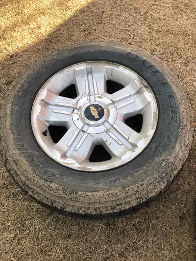 Selling a set of 4 used Chevy tires with Bridgestone Dueler P265/65R18 tire mounted on it. still has...