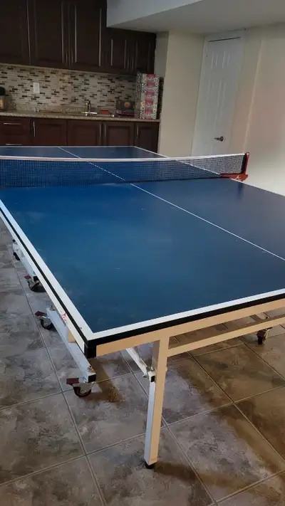 Ping pong table with 3 paddles and bunch of balls. Great condition barely use it anymore which is wh...