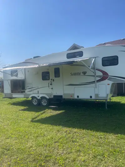 2011 Sabre 5th wheel trailer. 32’ long. Great family trailer with outdoor kitchen. This well built f...