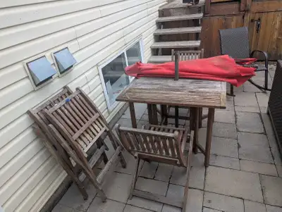 Small patio table with  4 chairs and umbrella and base., View more