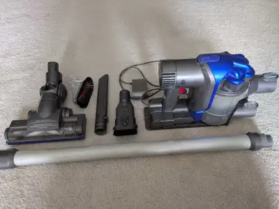 Versatile Dyson DC35 cordless vacuum is grey and blue. It has a motorized floor tool with carbon fib...