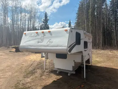 Arctic fox camper has slide out, electric jacks, built in propain generator with 105.4 hours and ac.