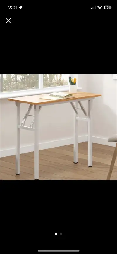 This folding desk features a wood-like top and a sturdy metal frame, perfect for small spaces. The d...