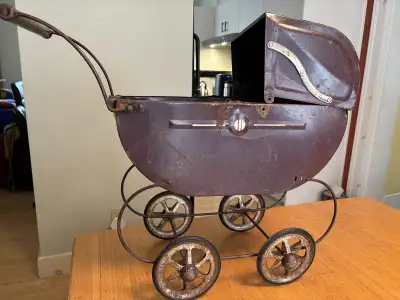 This vintage doll carriage is a charming piece of history, perfect for collectors or as a decorative...
