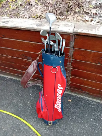 Cooper golf bag and 8 different golf clubs driver and putter included
